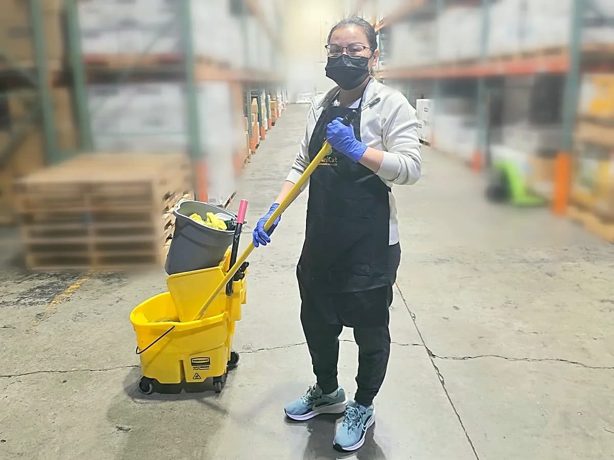 Janicat cleaner mopping a warehouse floor